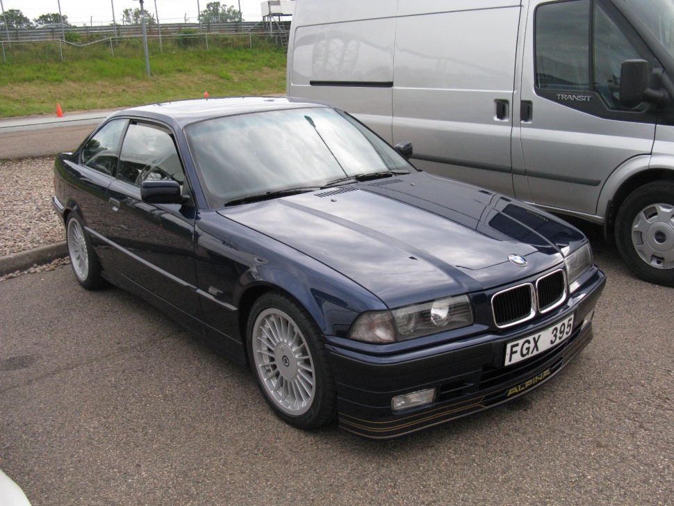Front angled view of classic coupe with sporty wheels