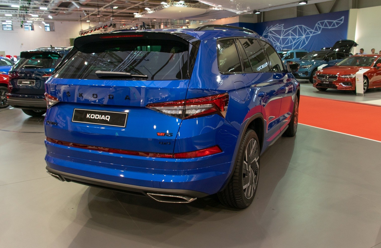 Rear view of blue SUV with LED tail lights and dual exhaust