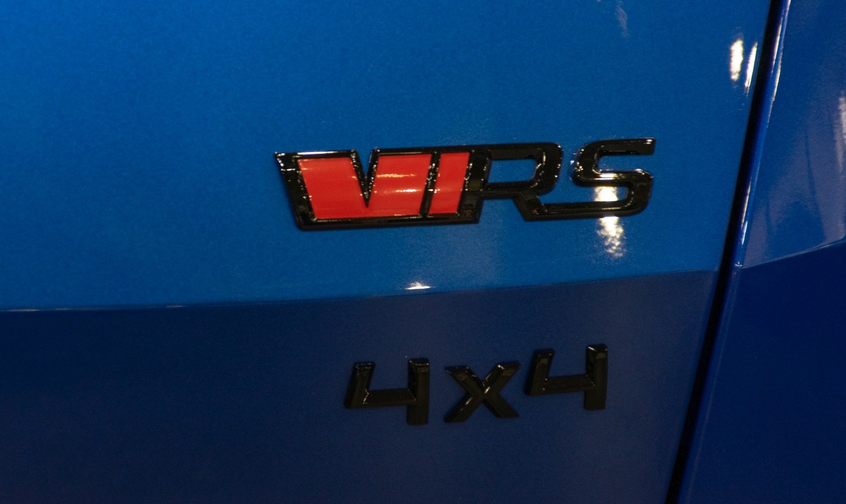 Close-up of VRS and 4x4 badges on blue vehicle body.