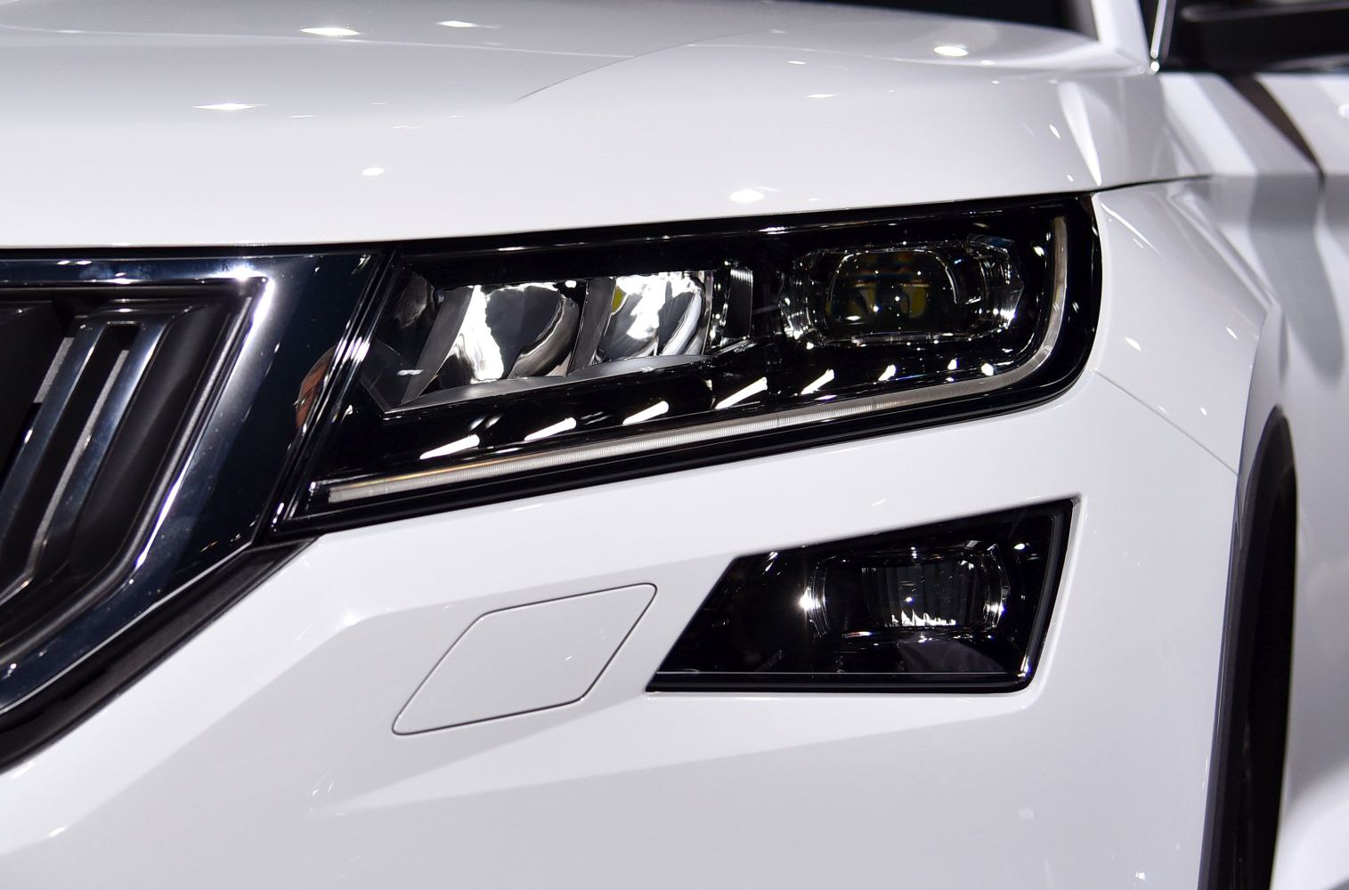 Close-up of headlight and front grille with LED lighting