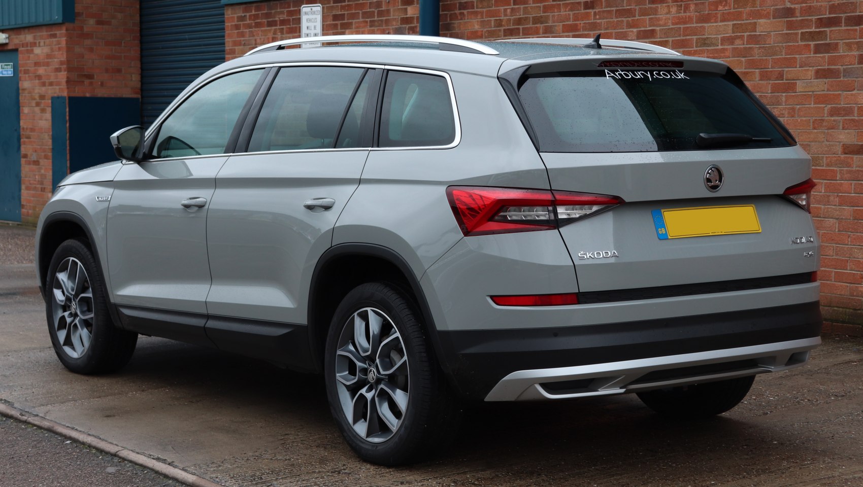 Rear side view of SUV with alloy wheels and roof rails