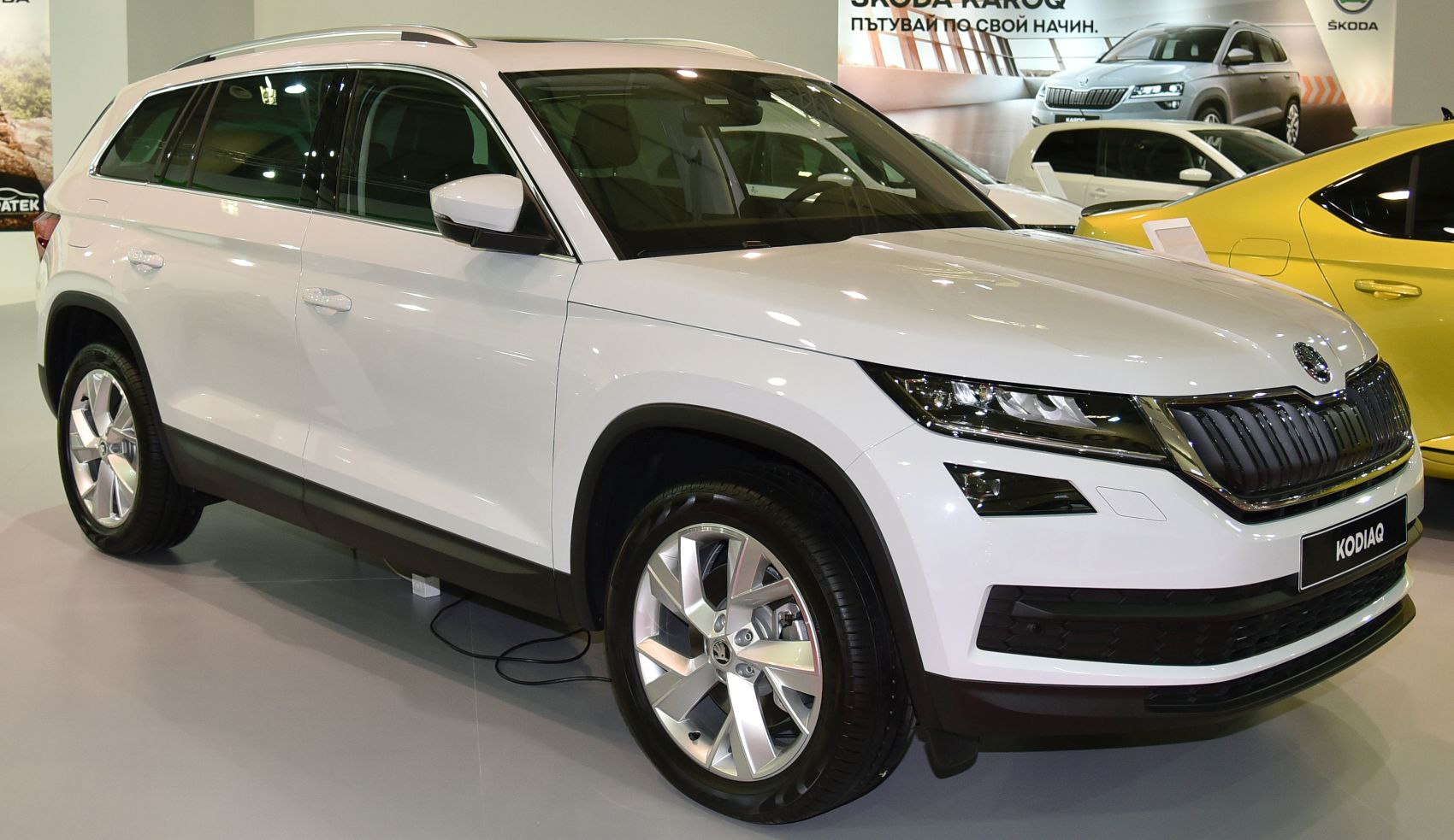 White SUV front and side view with distinctive grille and headlights