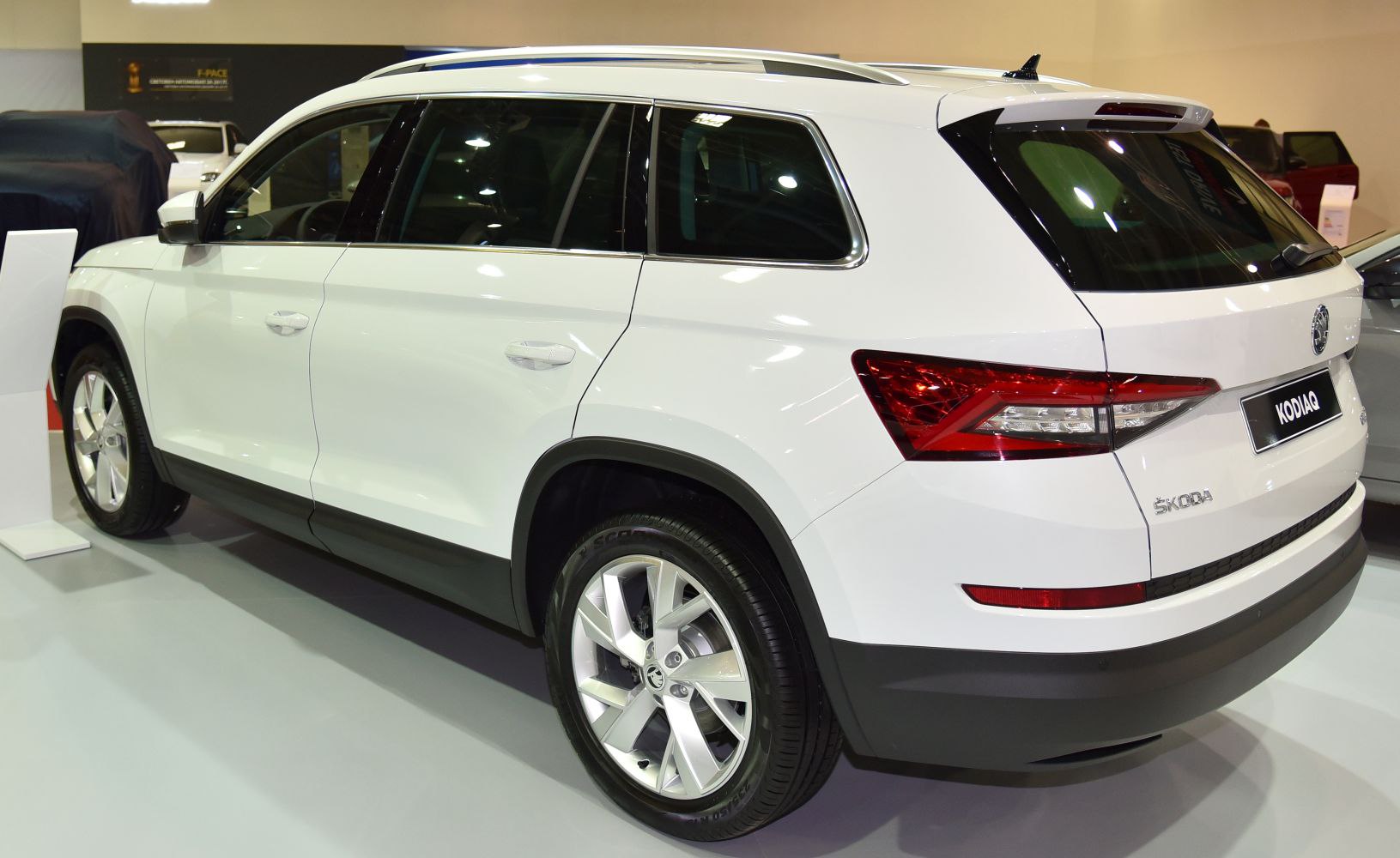 White SUV rear side view with alloy wheels and roof rails