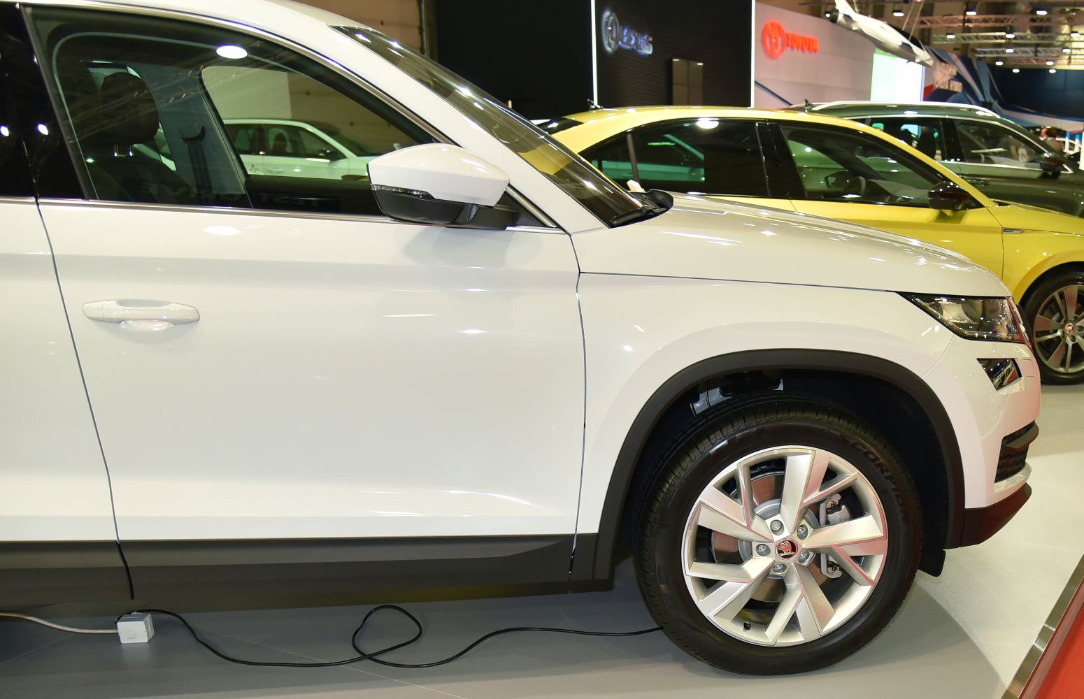 Side profile view emphasizing alloy wheels, door, and side mirror.