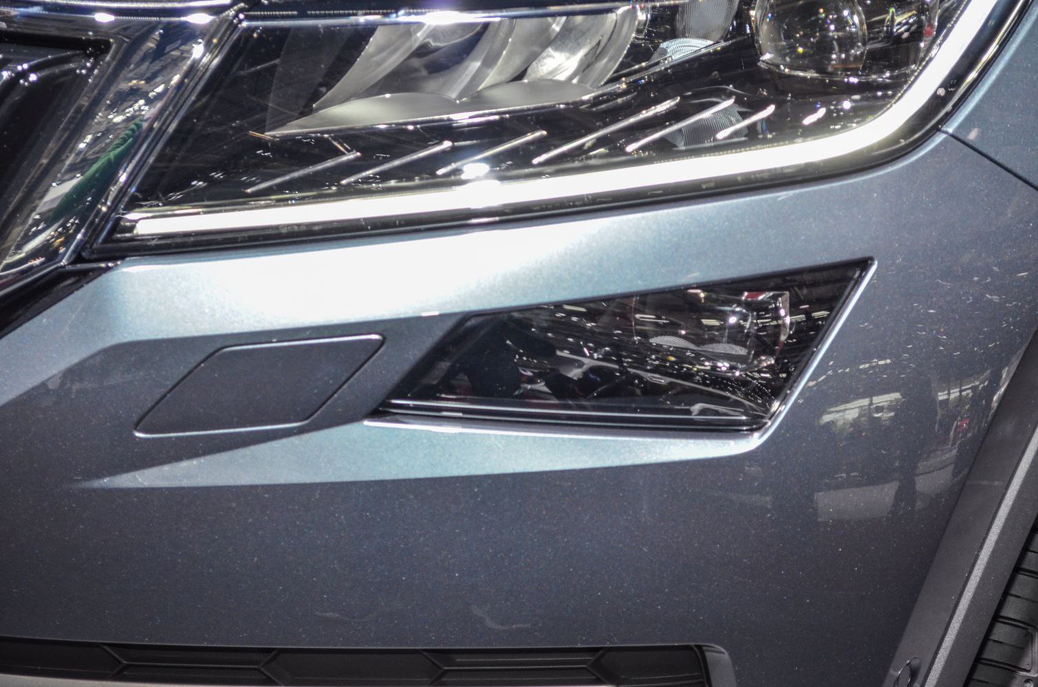 Close-up of front headlight and fog light with LED strip