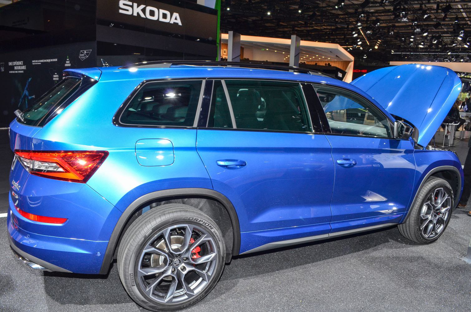 Blue SUV side profile with open hood and alloy wheels
