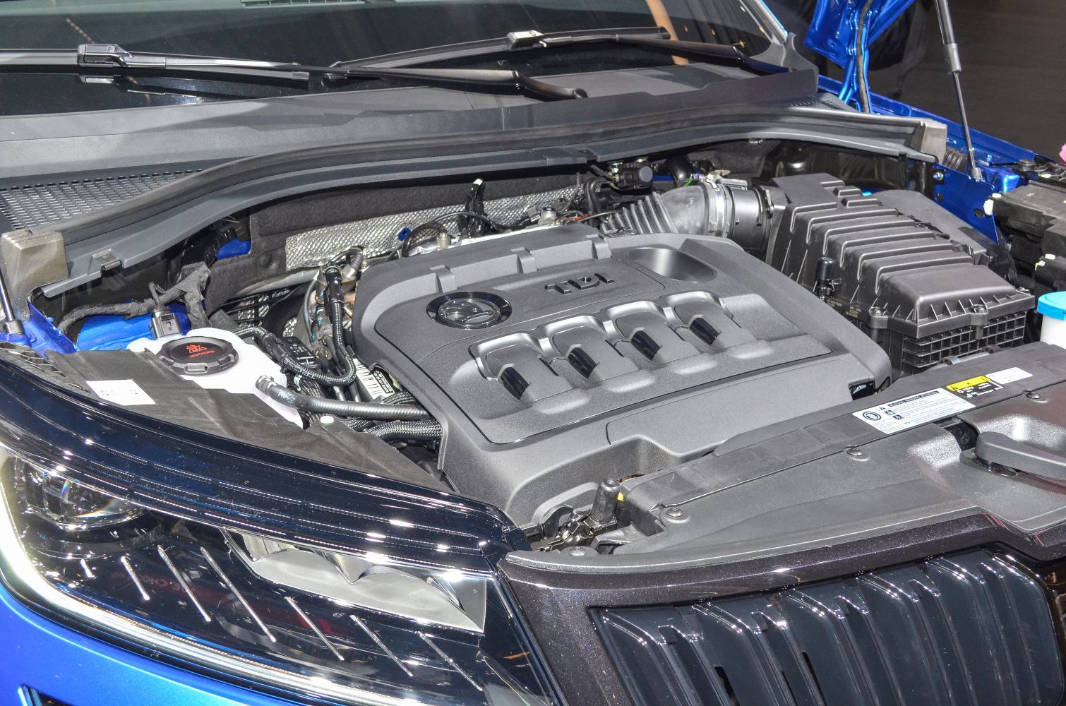 Close-up of diesel engine bay and front headlight assembly.