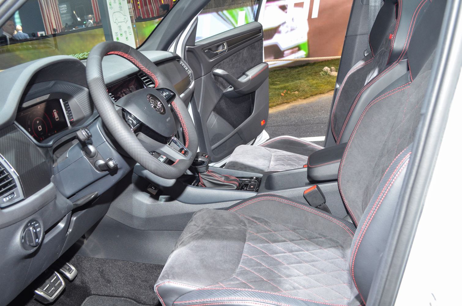 Sporty seats with red stitching and digital dashboard interior design