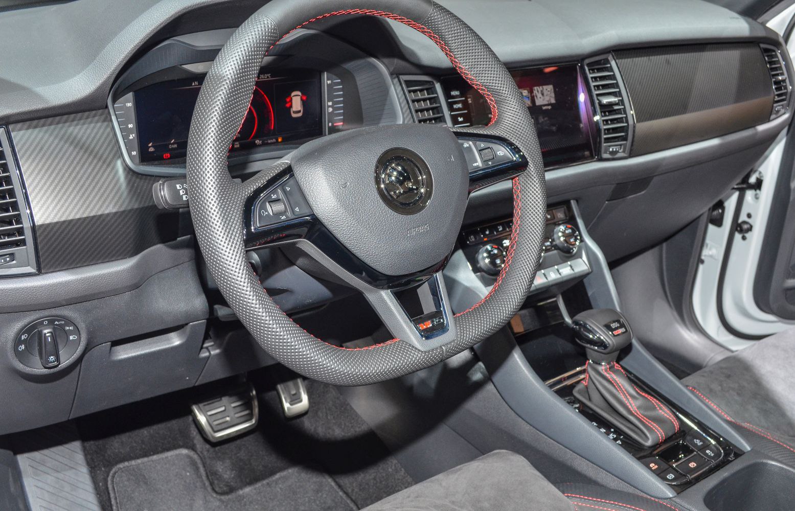 Interior dashboard, perforated steering wheel with red stitching, gear shift