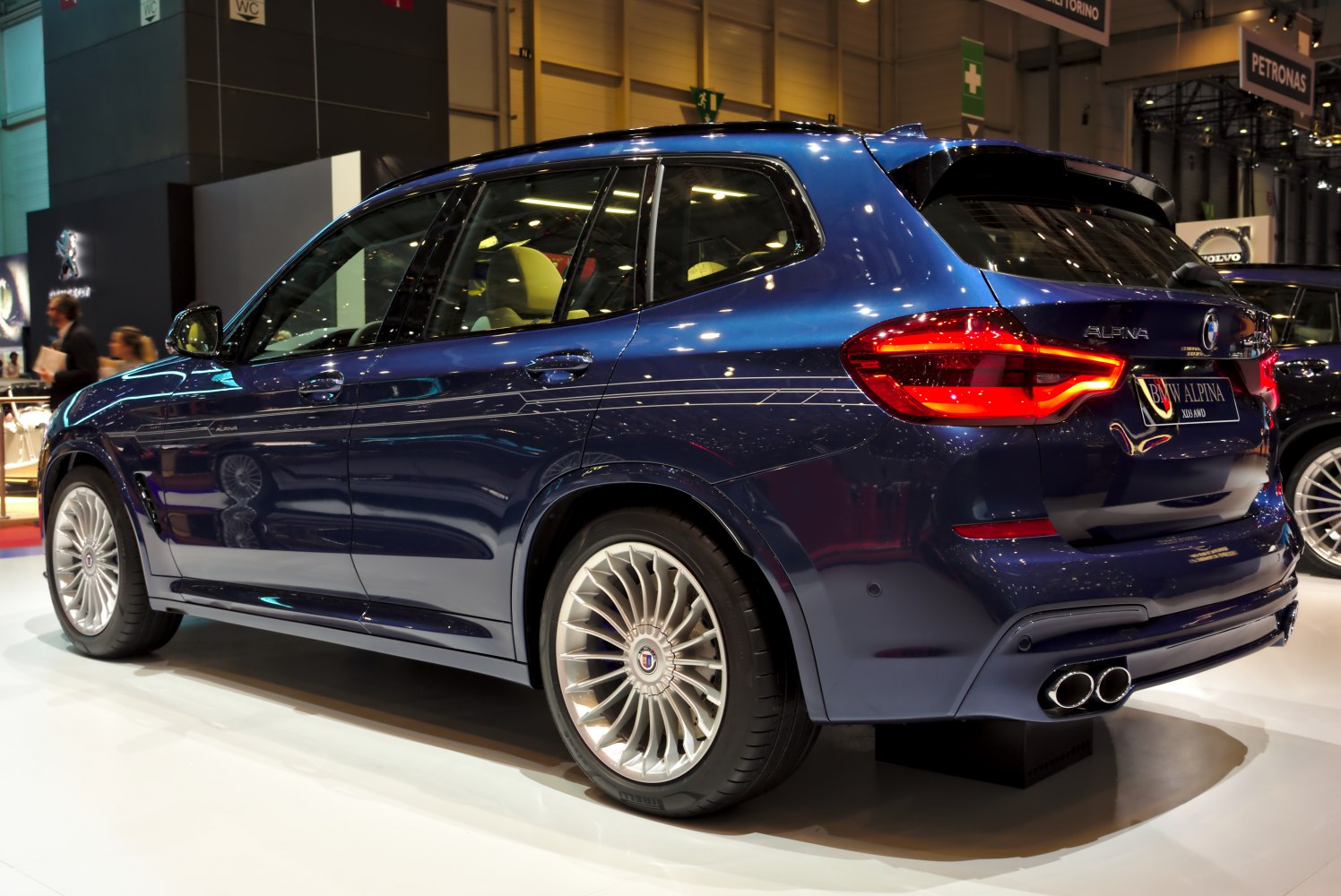 Rear side view with multi-spoke wheels and quad exhaust tips