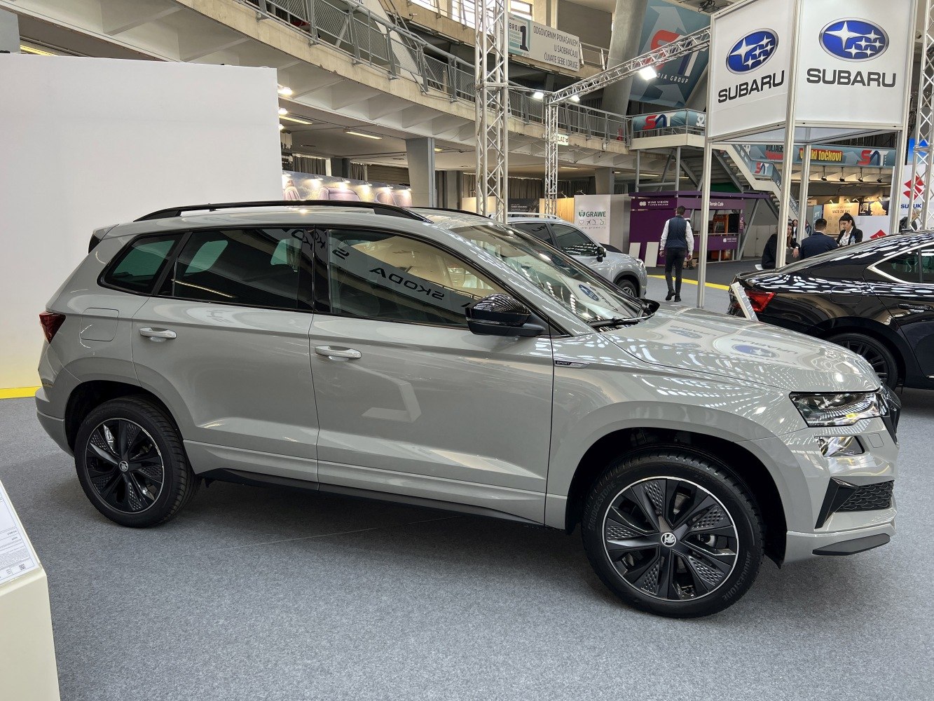 Side profile of modern mid-size SUV with dark alloy wheels and roof rails
