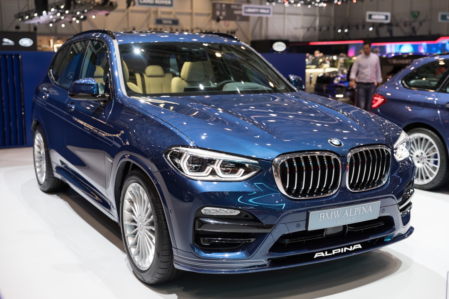 Luxury SUV front grille and intricate multi-spoke wheels in a sleek design
