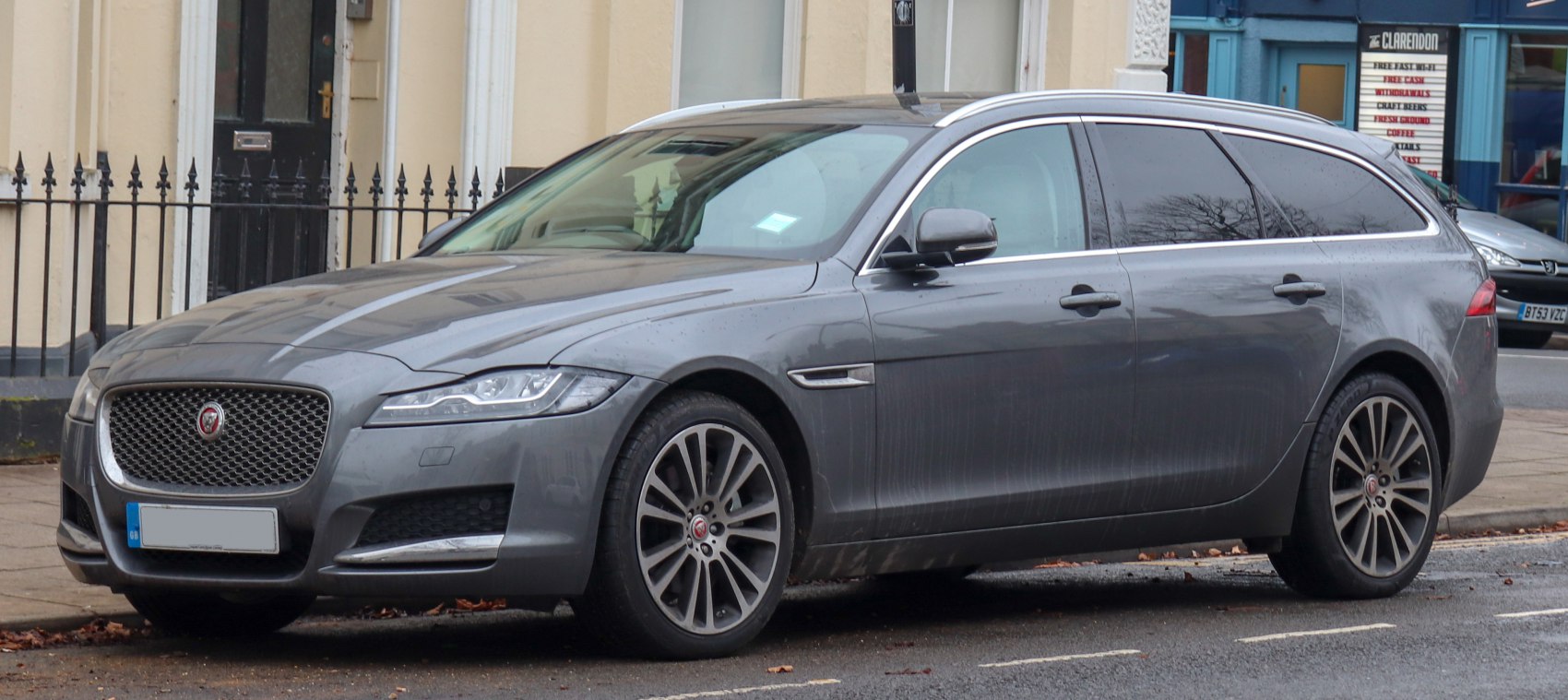 Luxury station wagon front side with alloy wheels and sleek profile