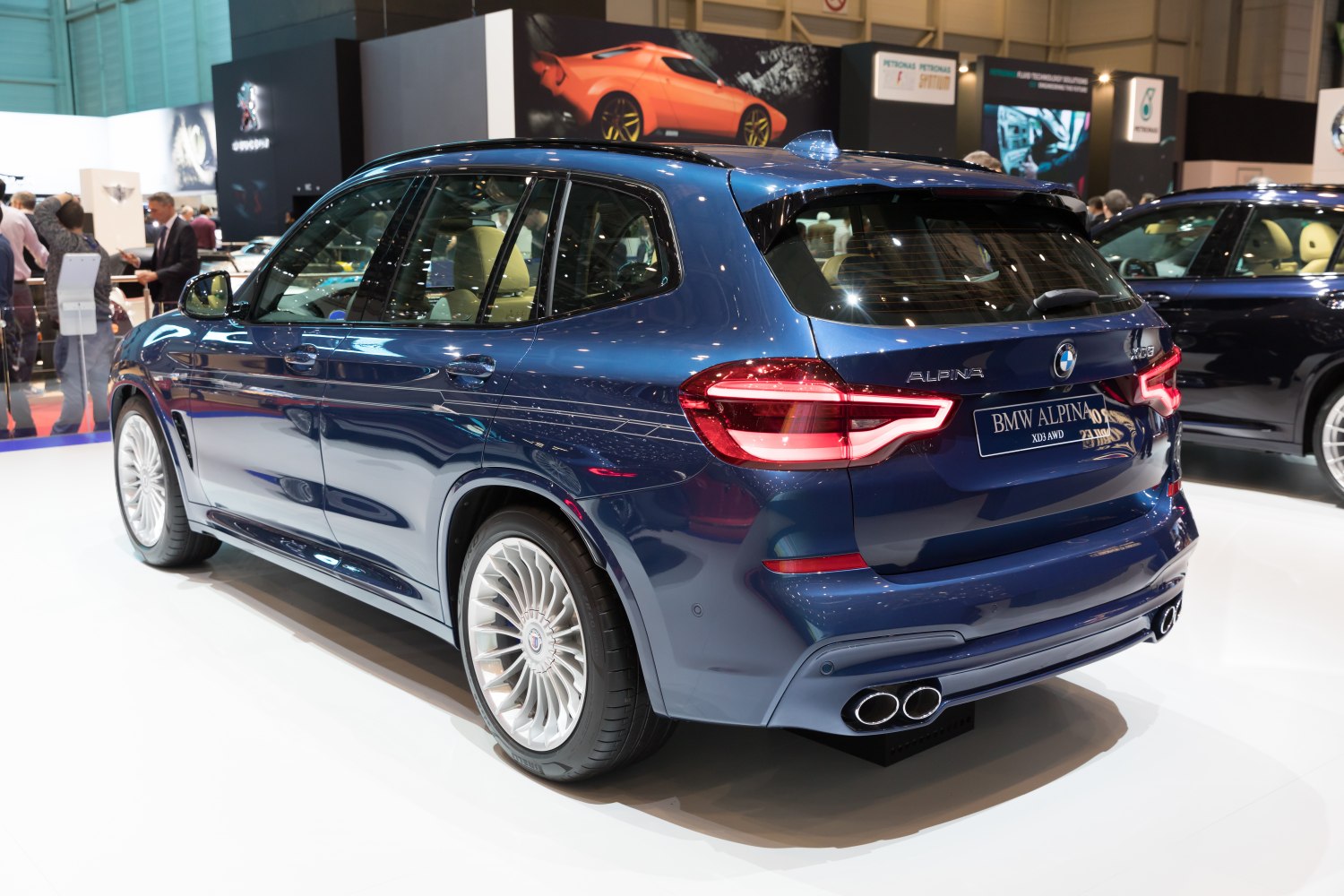 Rear three-quarter SUV with quad exhaust and multi-spoke rims
