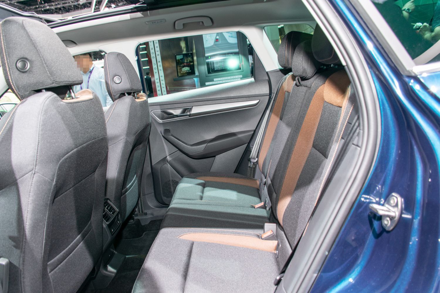 Rear passenger seats with fabric upholstery and modern door panel