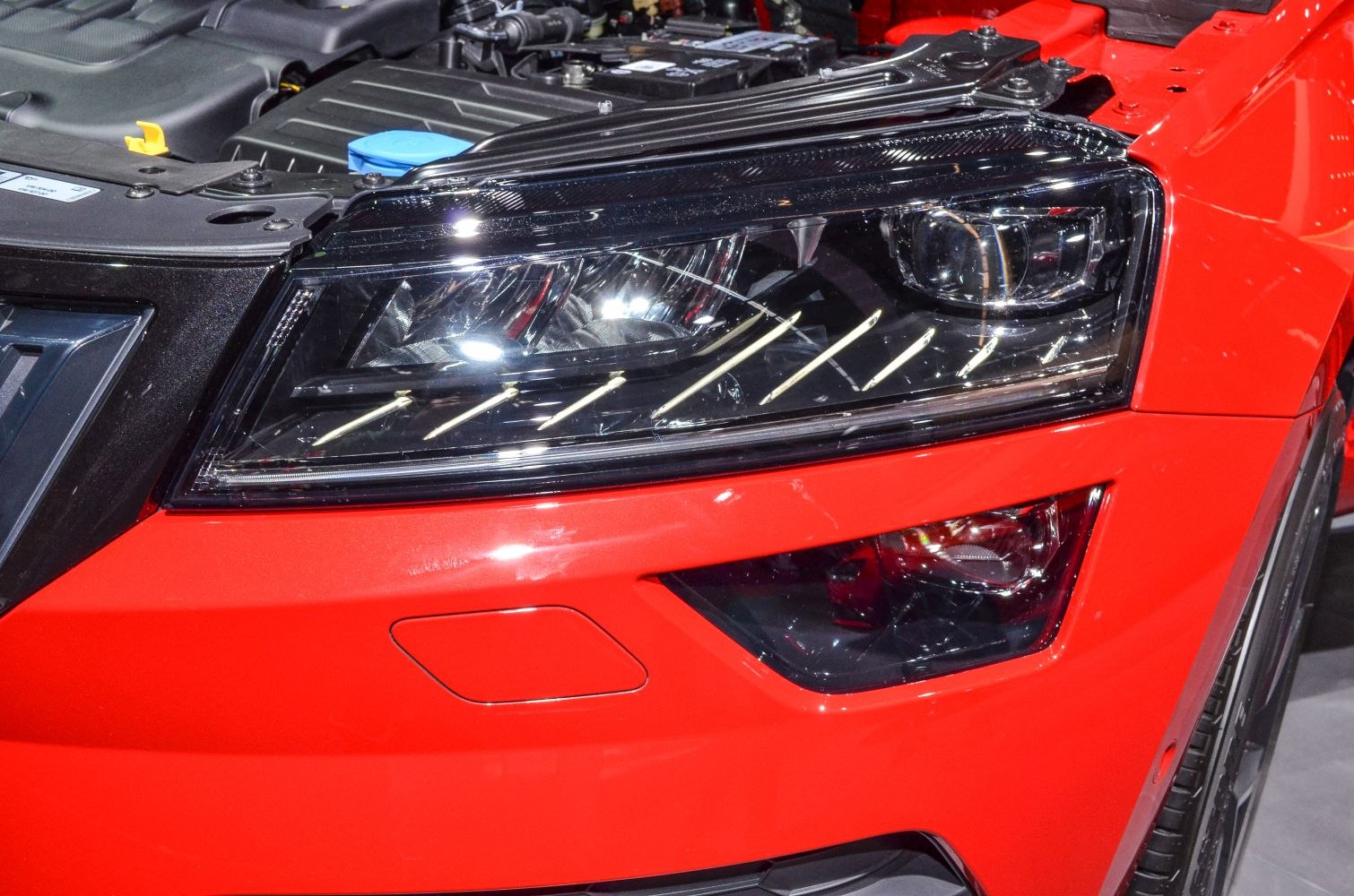 Close-up of modern headlight with LED lights and front bumper detail