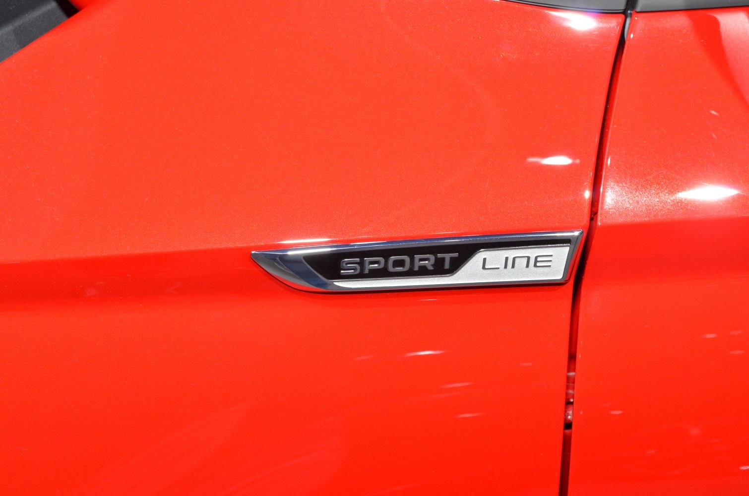 Close-up of Sport Line badge on red car panel