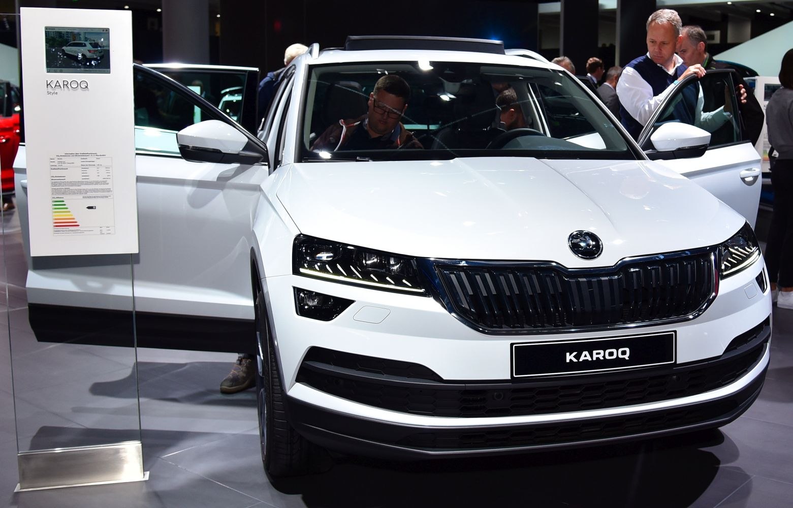 Front view of a white SUV with LED headlights and bold grille.