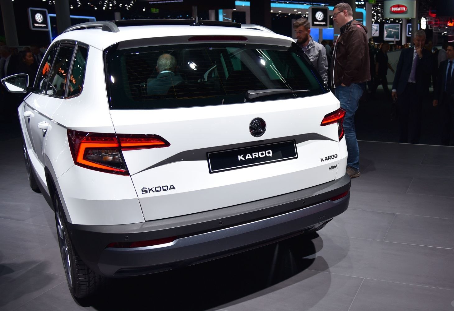 White compact SUV rear with LED tail lights and rear wiper at auto show