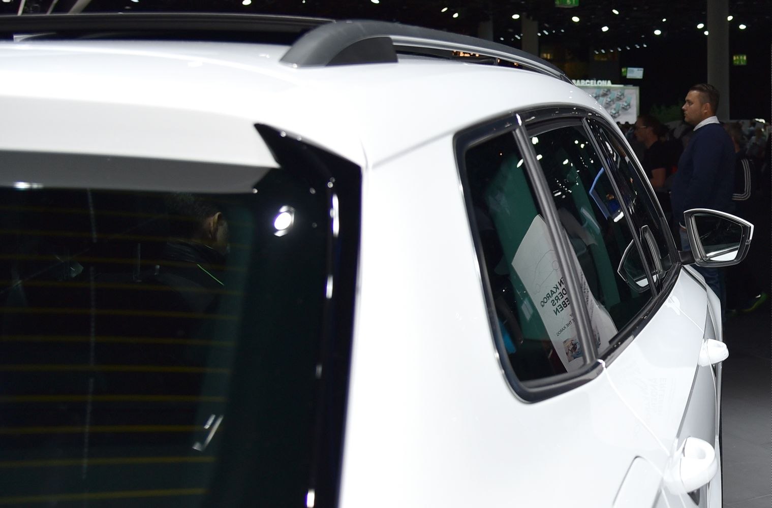 Close-up of rear side window with roof rail and side mirror