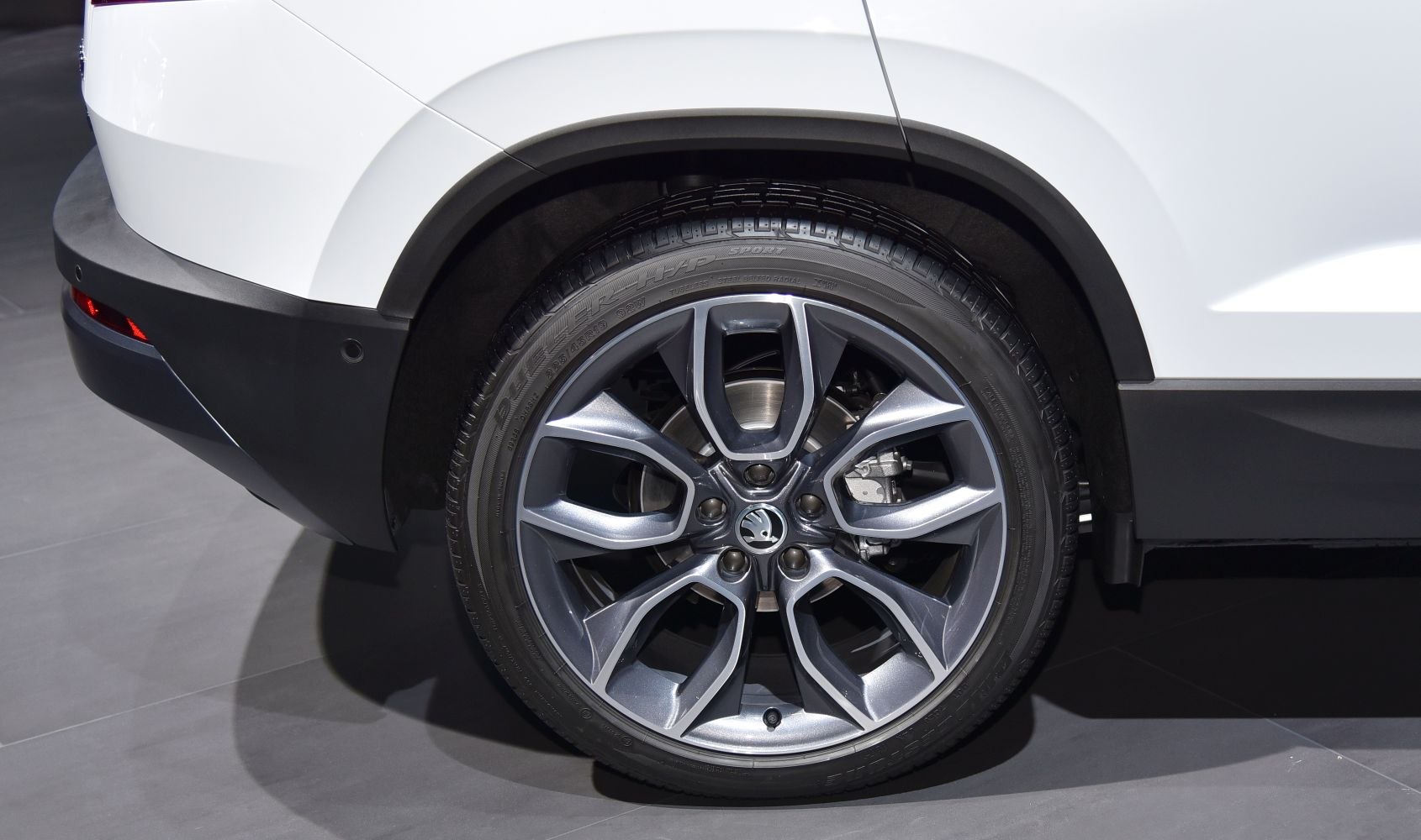 Close-up of alloy wheel and rear fender with tire tread and arch detail