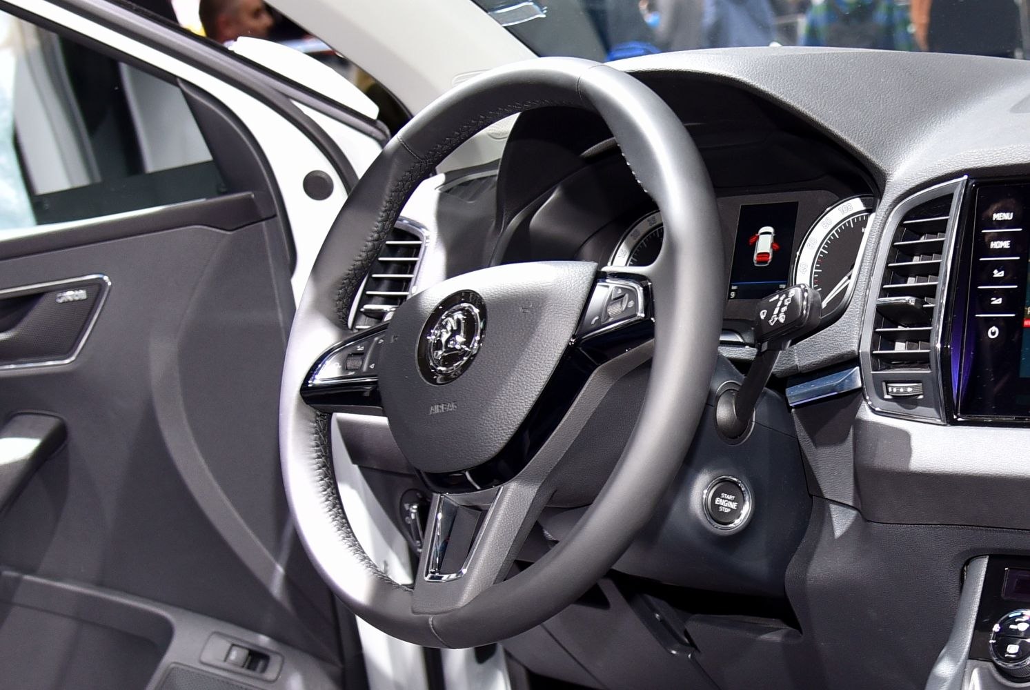 Steering wheel, dashboard display, and engine start button close-up