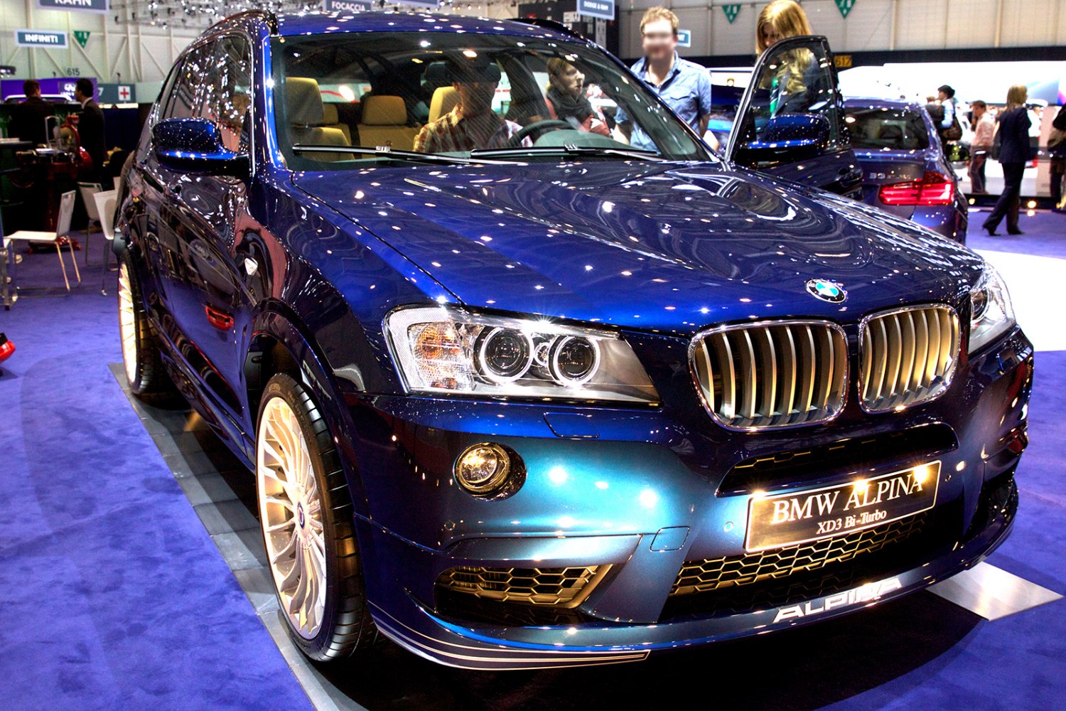 Close-up of front grille and dual headlights on blue SUV