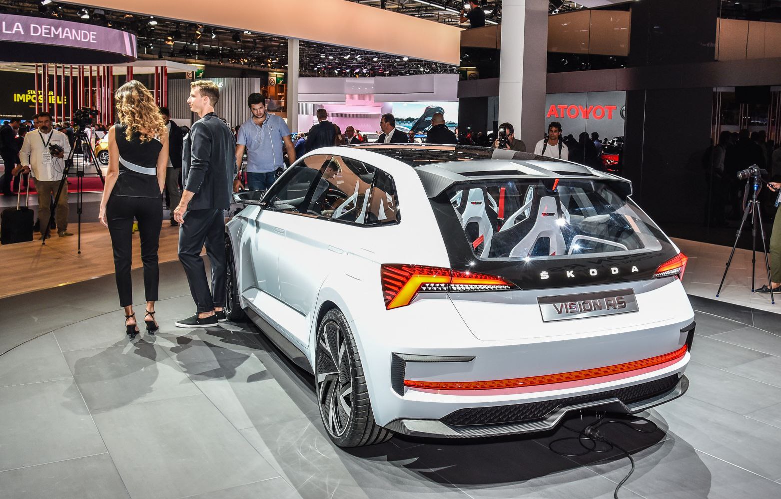 Rear view of a futuristic hatchback with unique taillights and mesh wheels