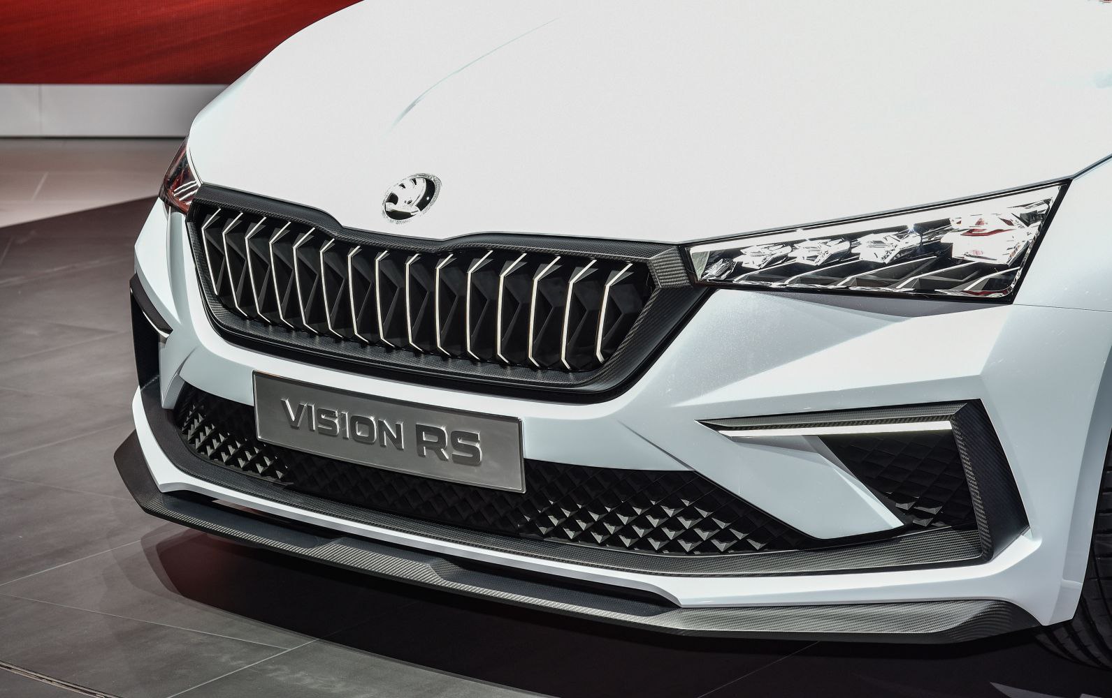 Close-up of front grille and sharp LED headlight with aerodynamic bumper.