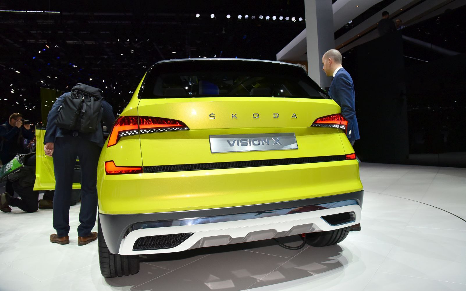 Bright yellow hybrid SUV rear with futuristic taillights and bold design.