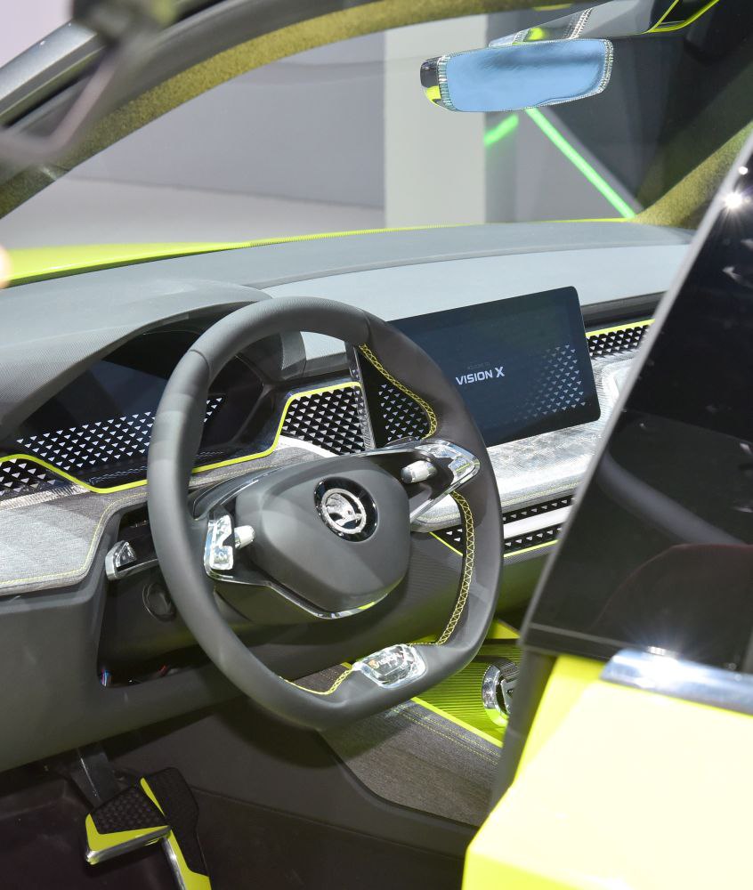 Futuristic car interior with digital dashboard and unique steering wheel