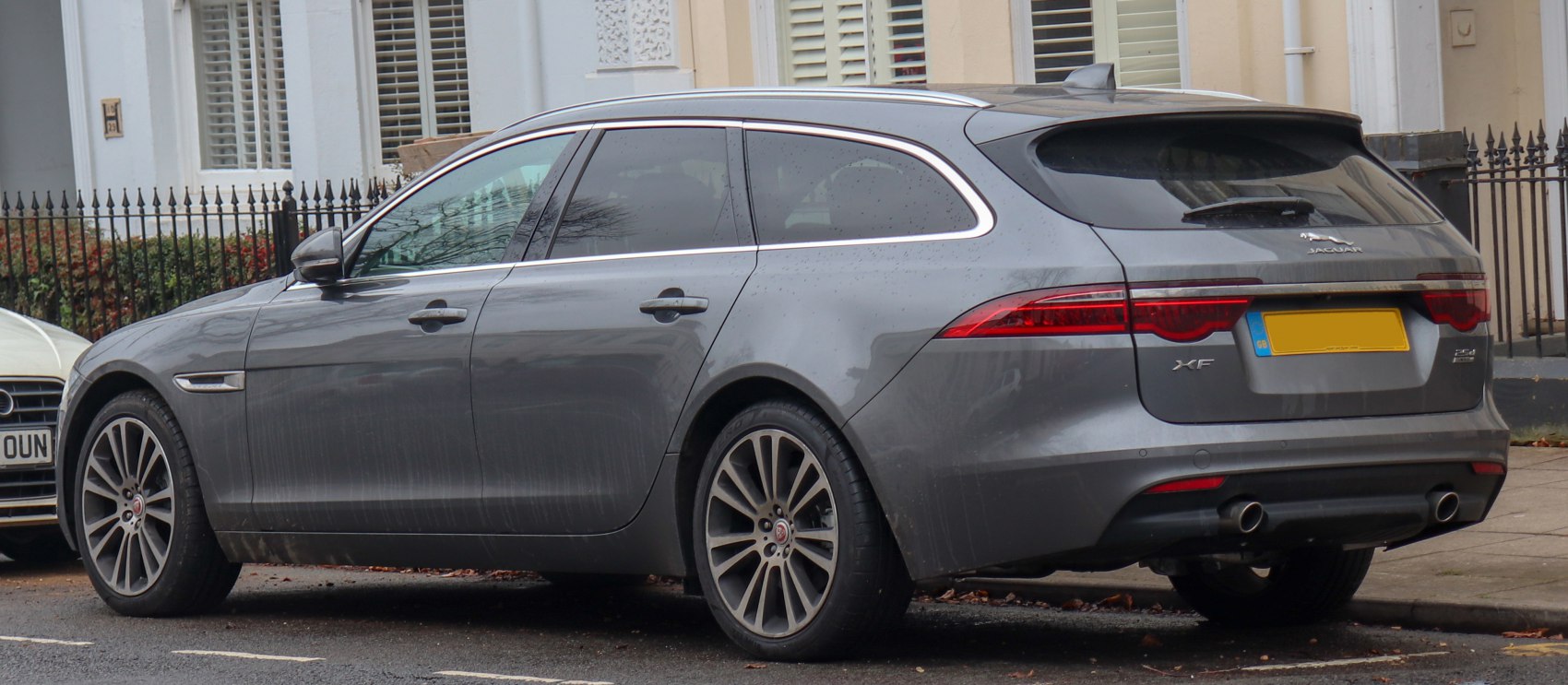Rear side view of a sleek station wagon with distinctive tail lights and alloy wheels