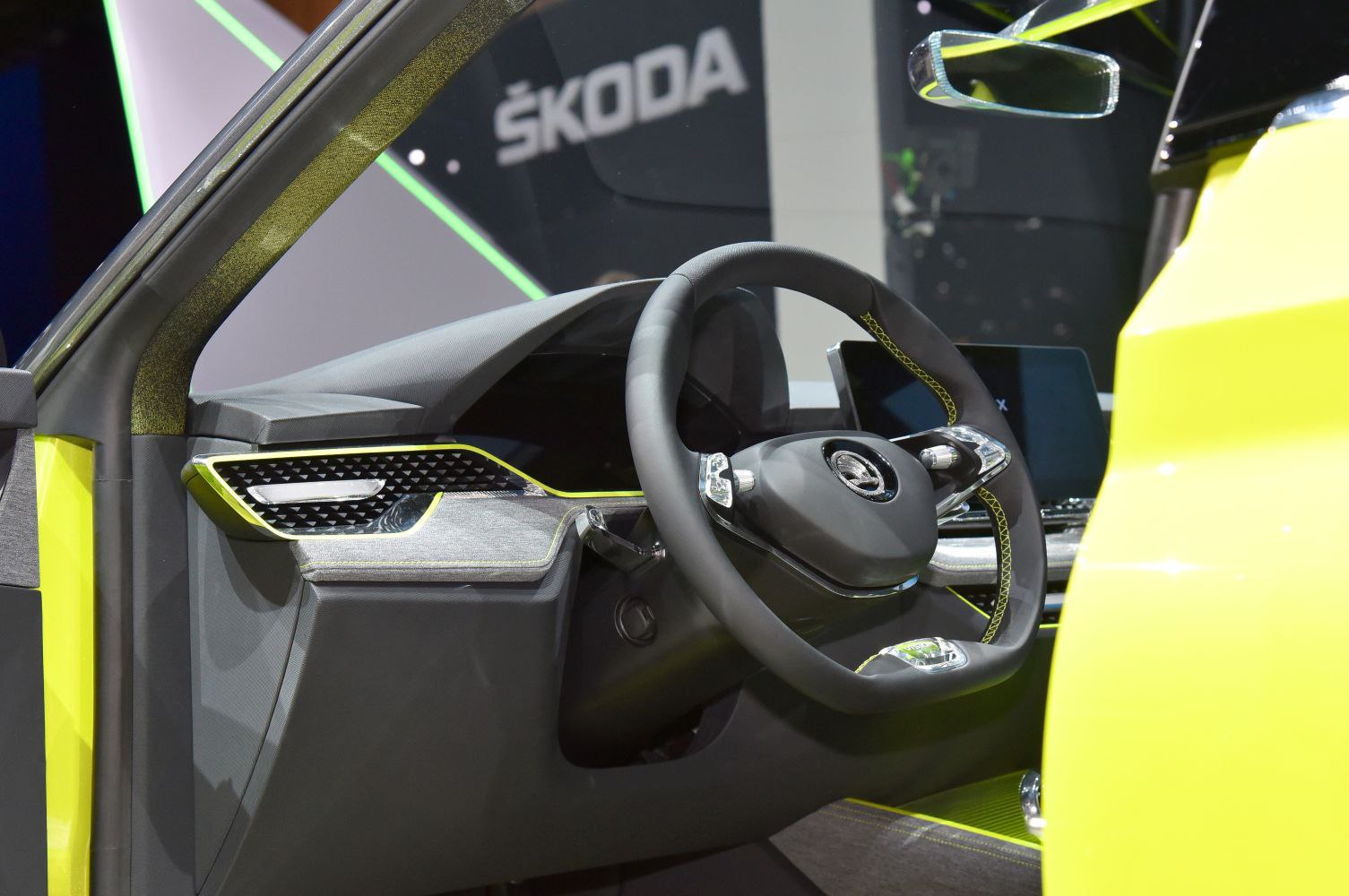 Futuristic steering wheel and dashboard design with digital display and sporty accents