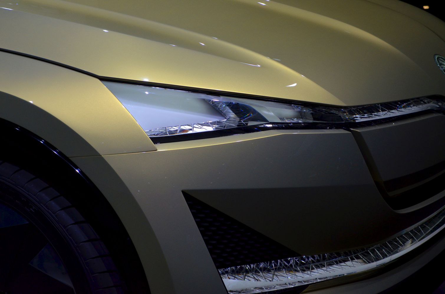 Close-up of futuristic front headlight and sleek body panel