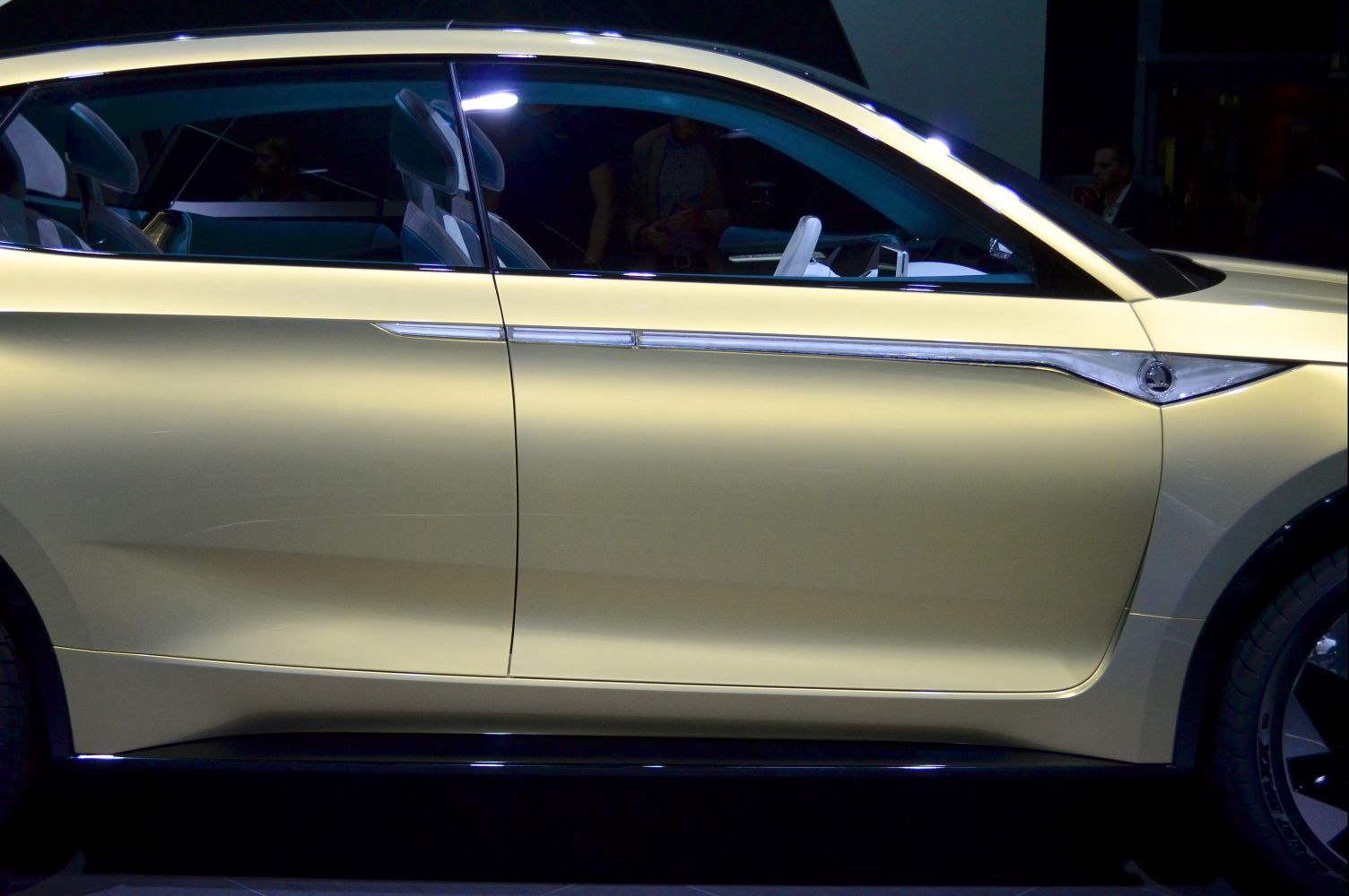 Futuristic side profile with sleek doors and visible modern interior seats