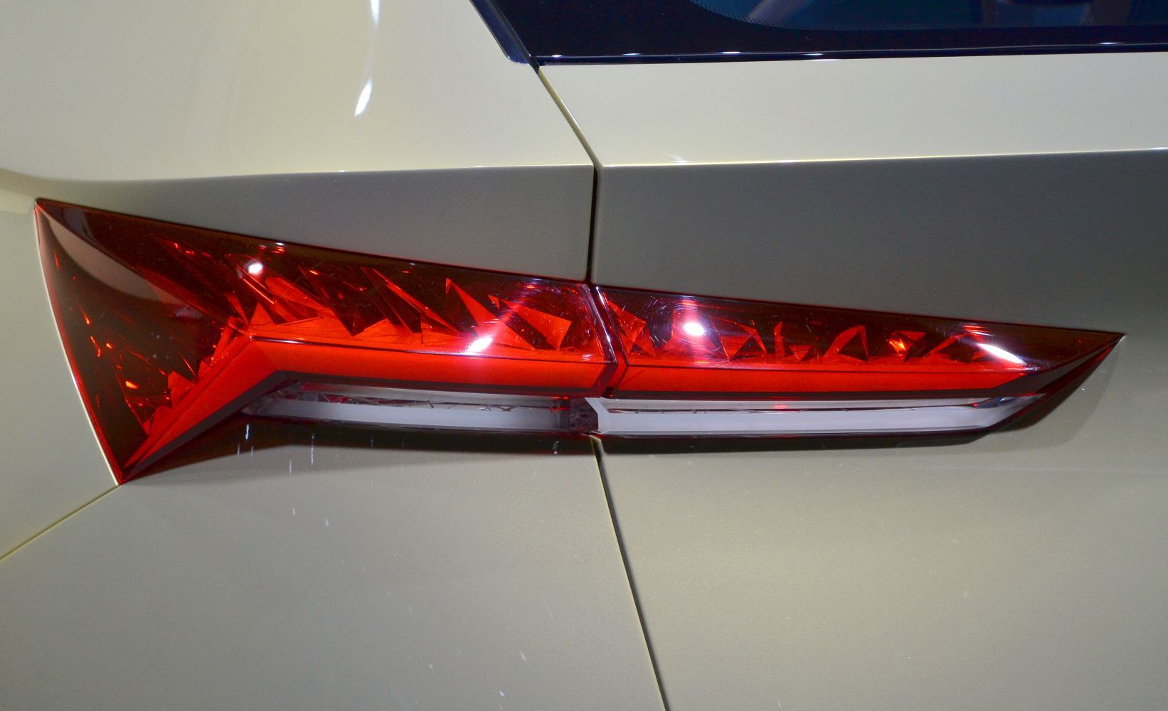 Angular rear tail light with geometric facets and sharp edges.