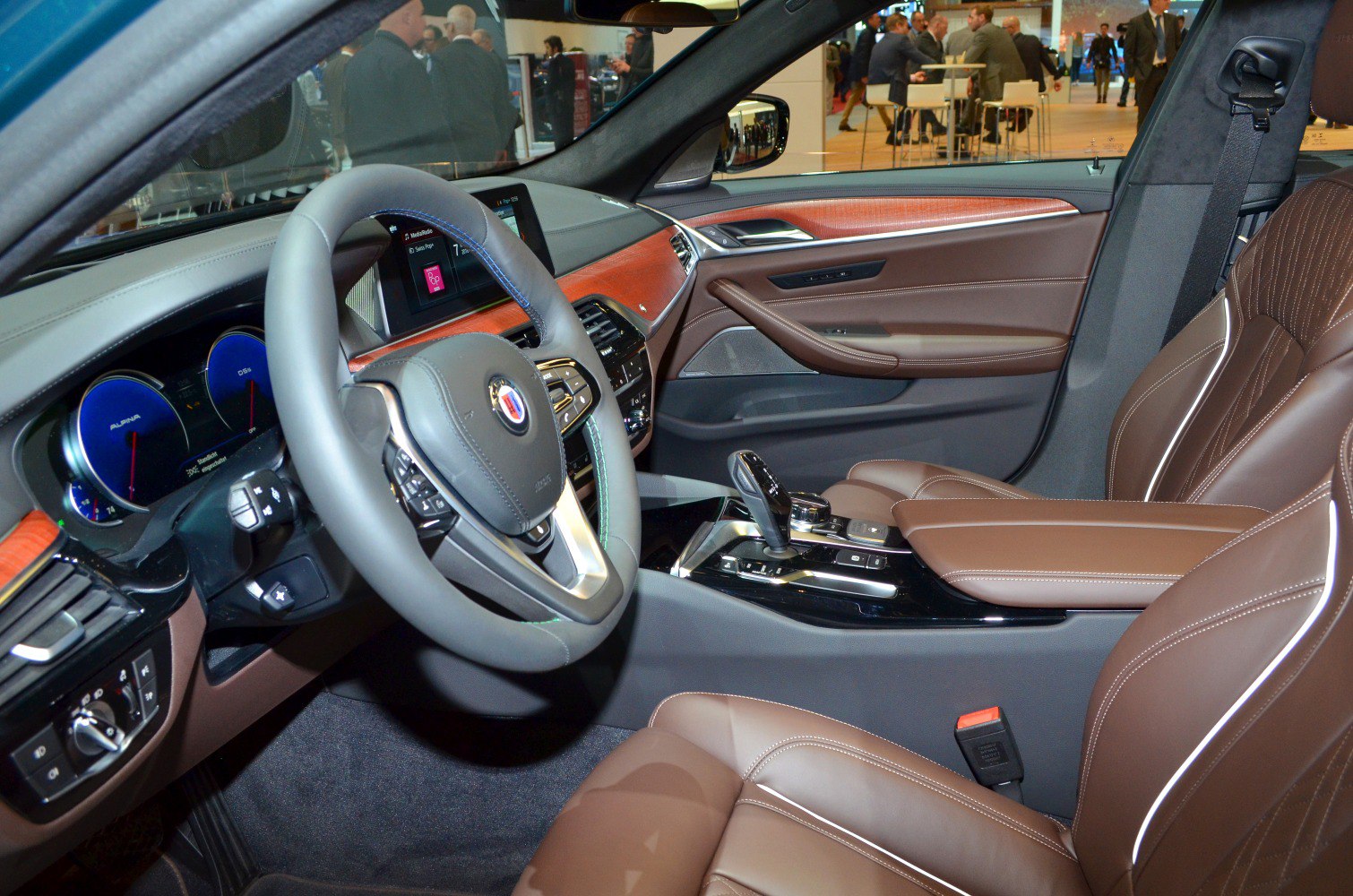 Luxury brown leather interior with wooden dashboard trim and modern control elements