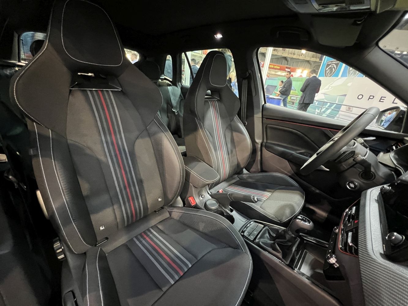 Front sport seats with striped upholstery and car interior dashboard