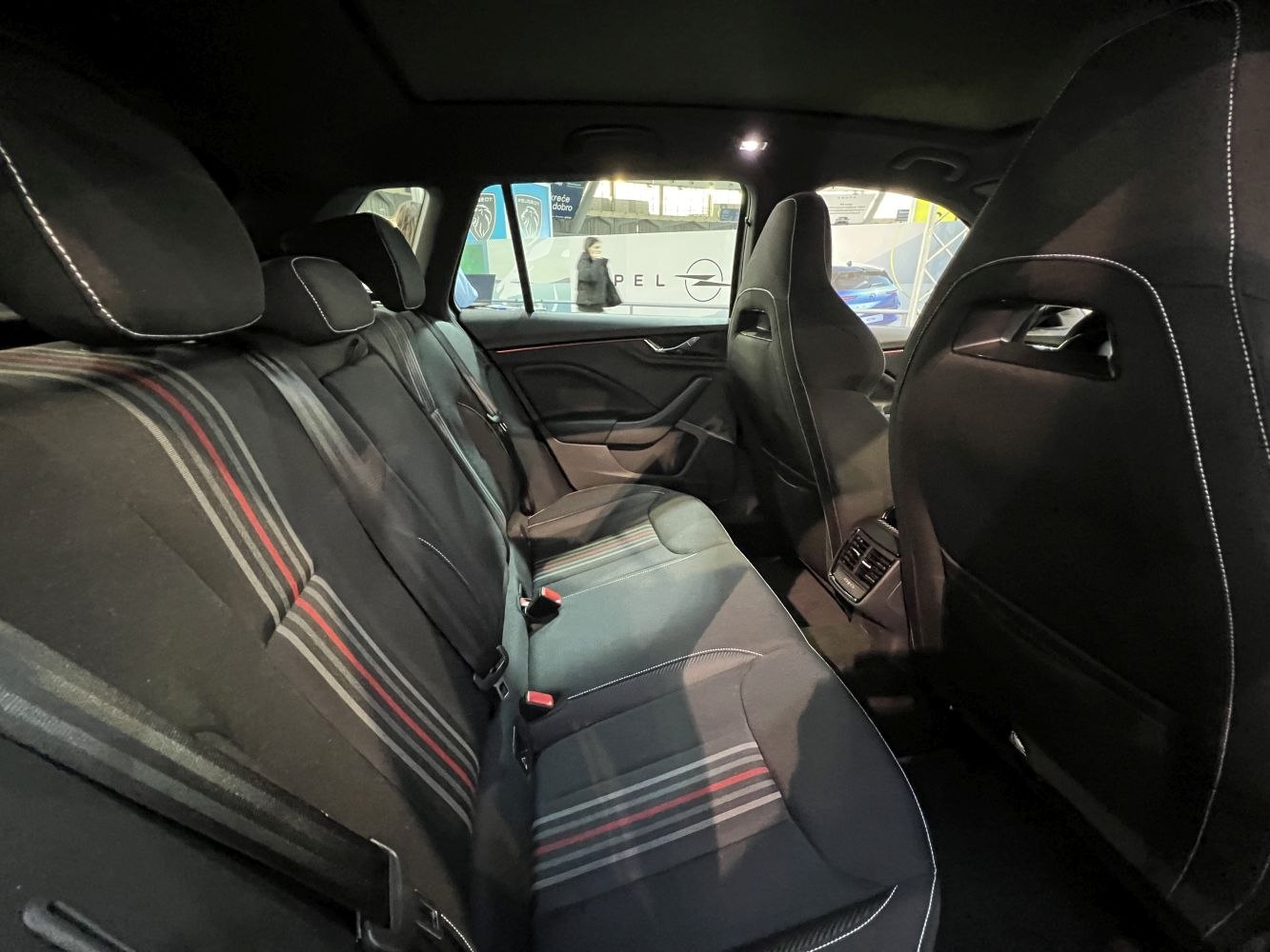 Rear passenger seats with patterned upholstery and integrated air vents.