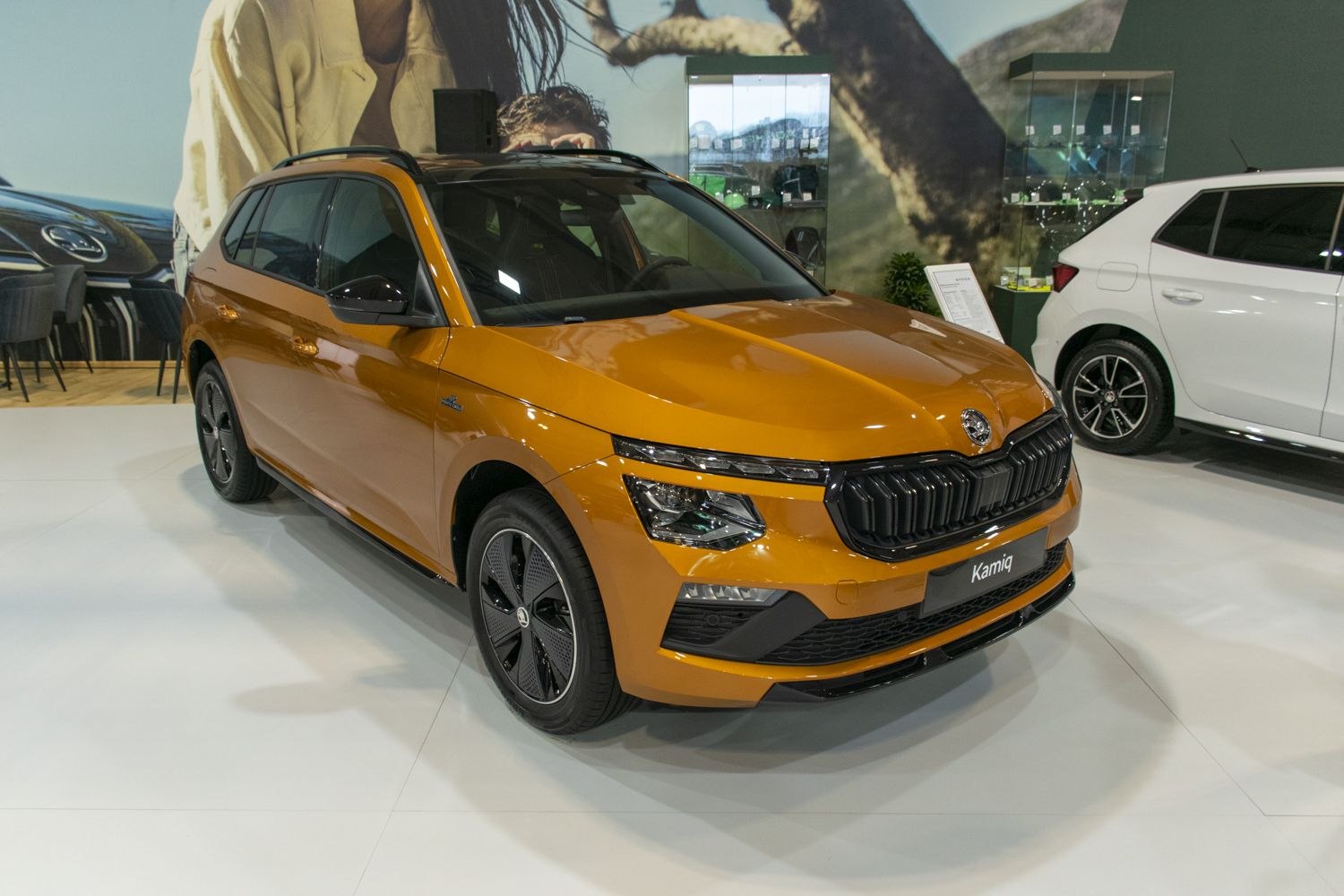 Orange compact SUV front view with black grille and LED headlights