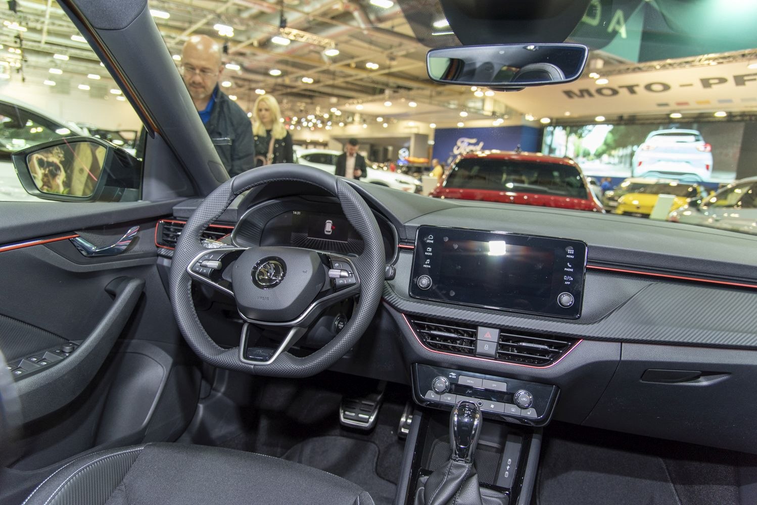 Sporty steering wheel and digital dashboard with central infotainment screen