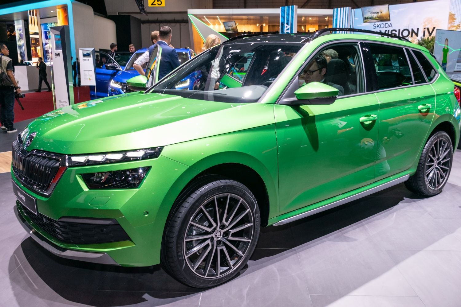 Bright green exterior with sleek headlights and detailed alloy wheels.