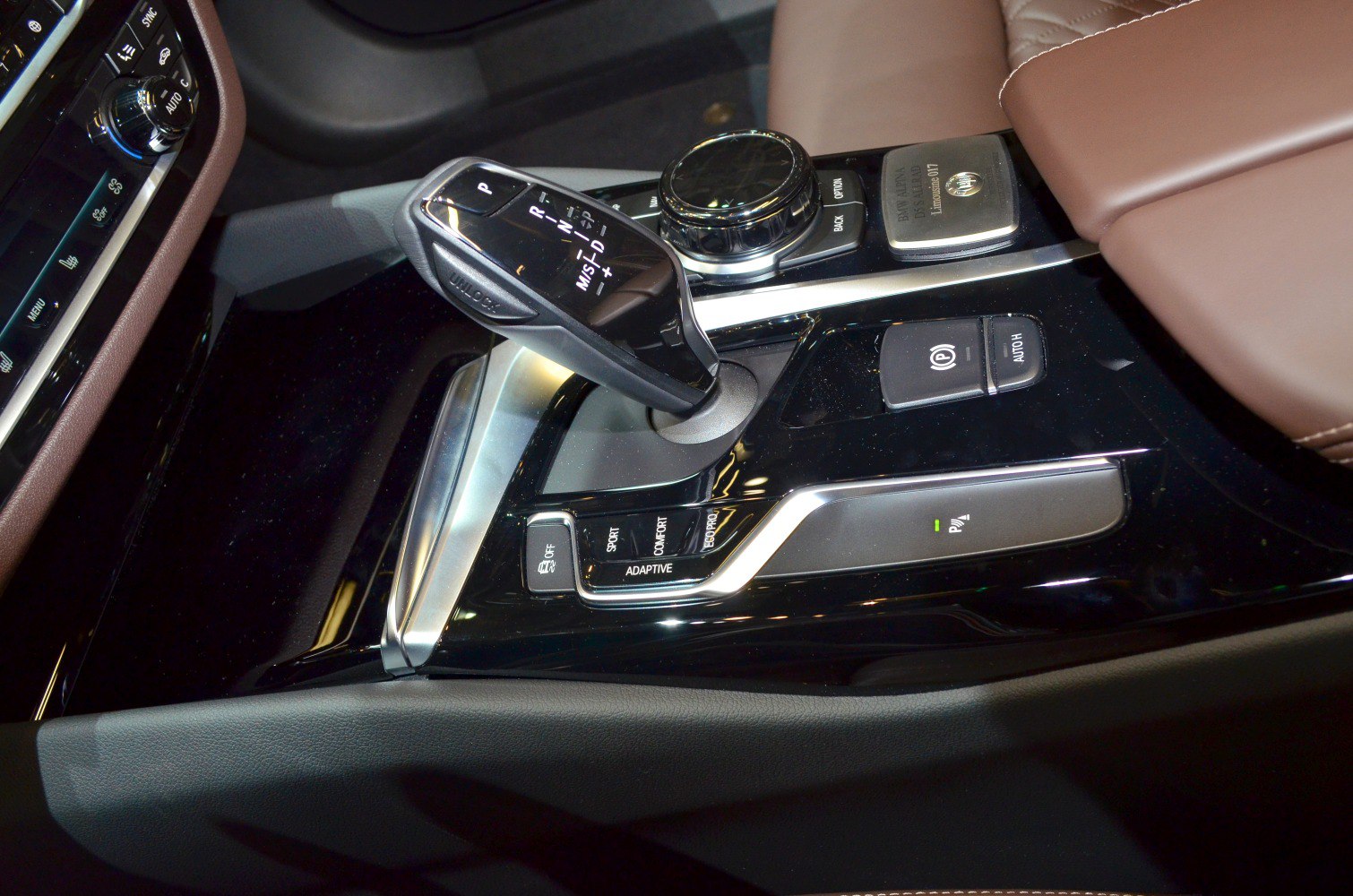 Gear shift lever and driving mode controls in luxury sedan center console