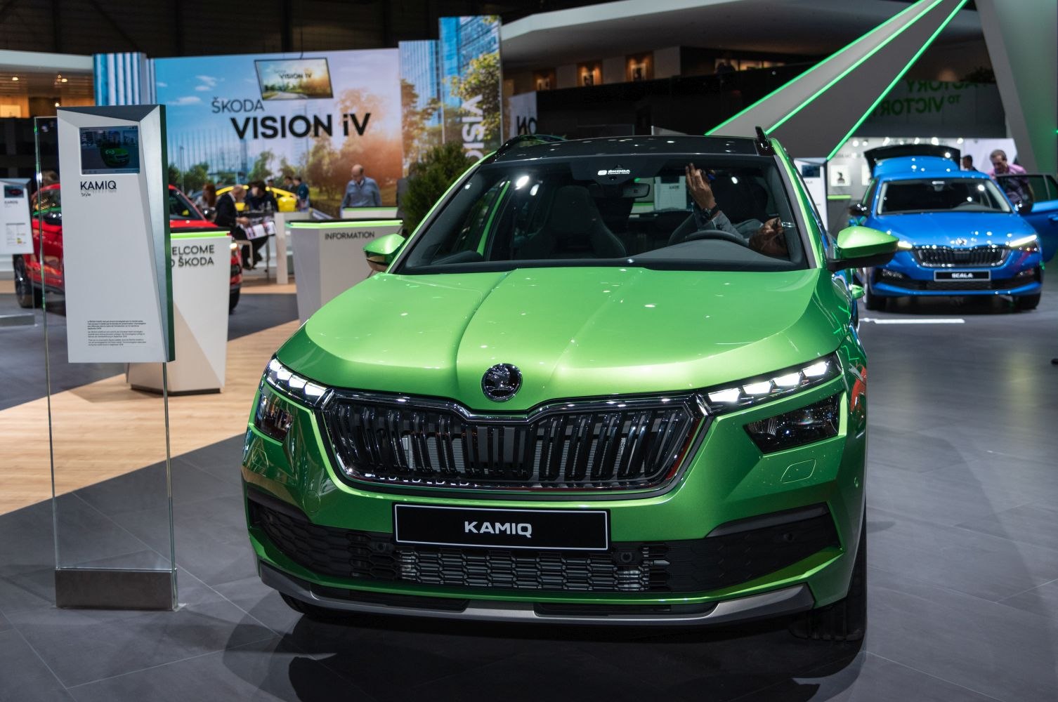 Front view of green compact SUV with LED headlights and wide grille