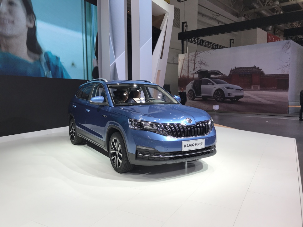Blue compact SUV front view with grille, headlights, and alloy wheels