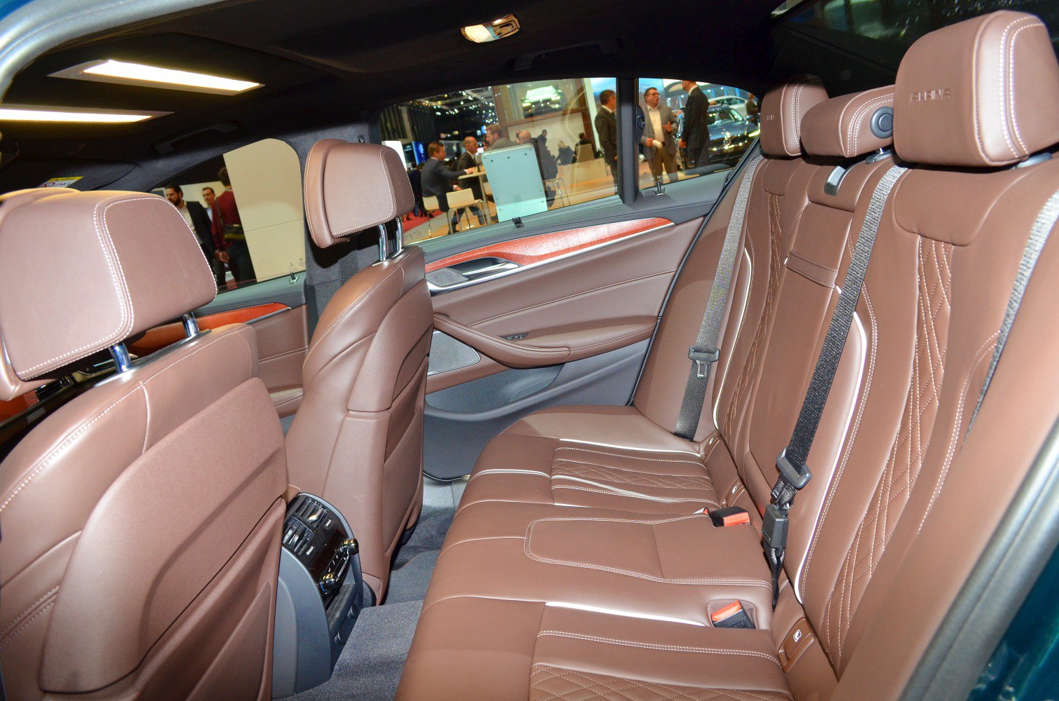 Brown leather rear seats with quilted design and detailed stitching in spacious interior