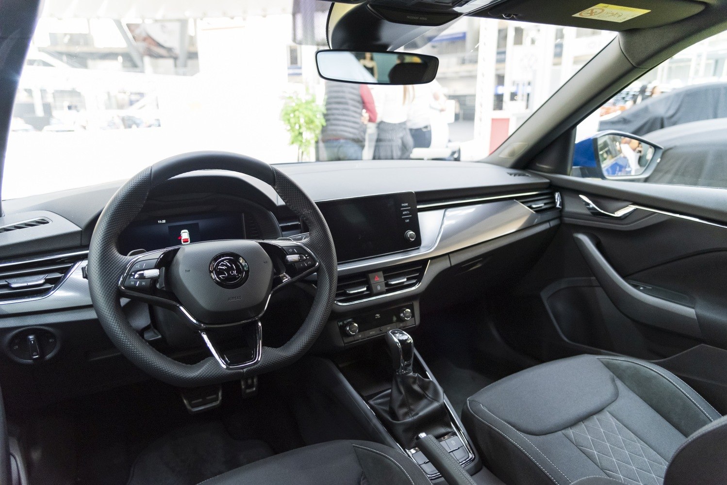 Modern steering wheel and central console with digital display and gear shift