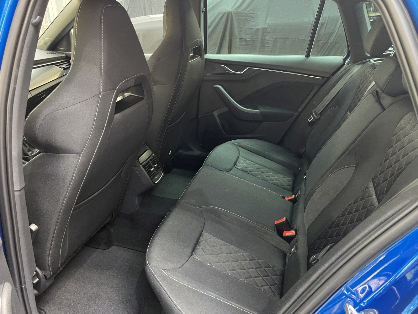 Rear seating area with black upholstery and diamond stitching