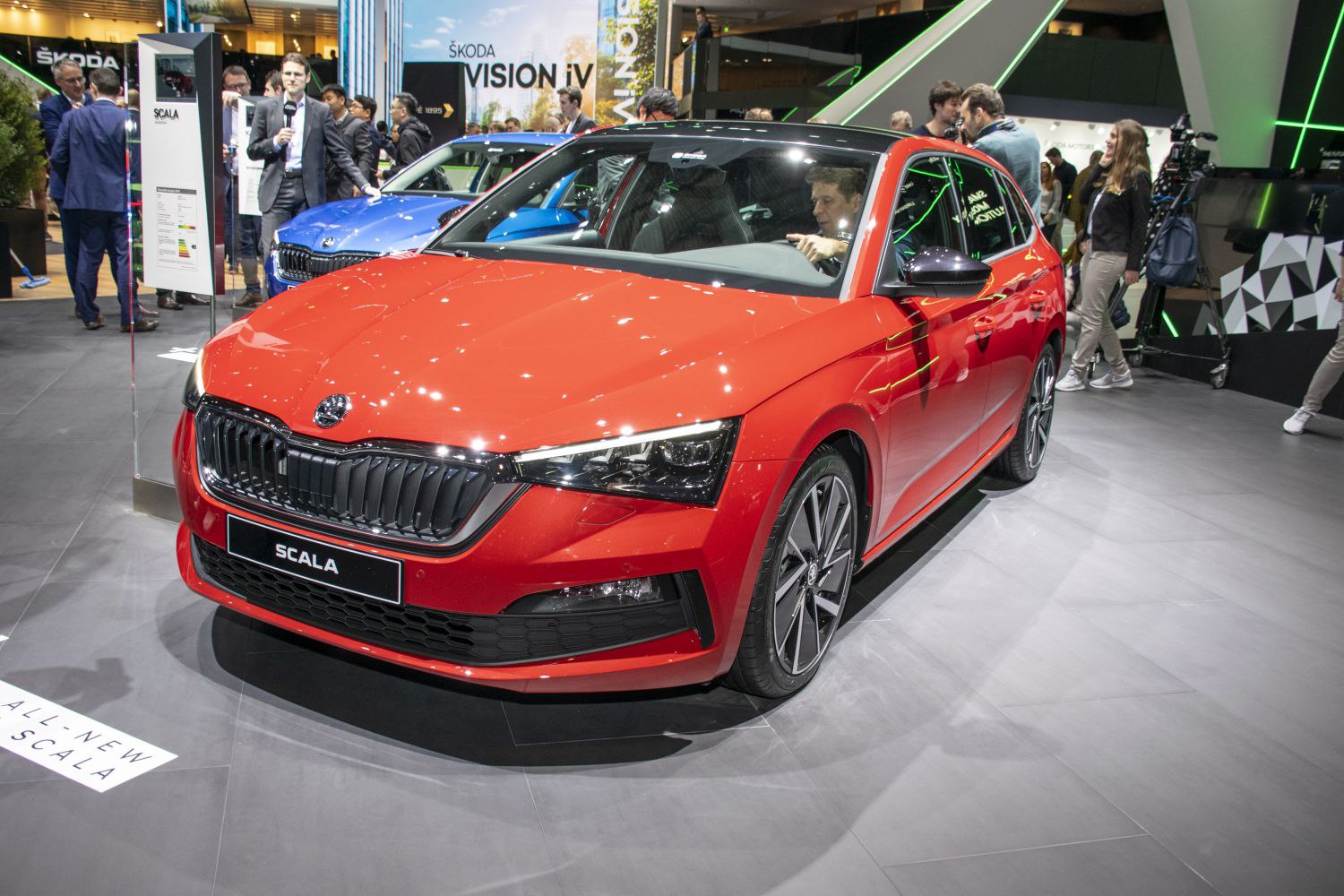 Red hatchback with LED headlights and black aggressive front grille