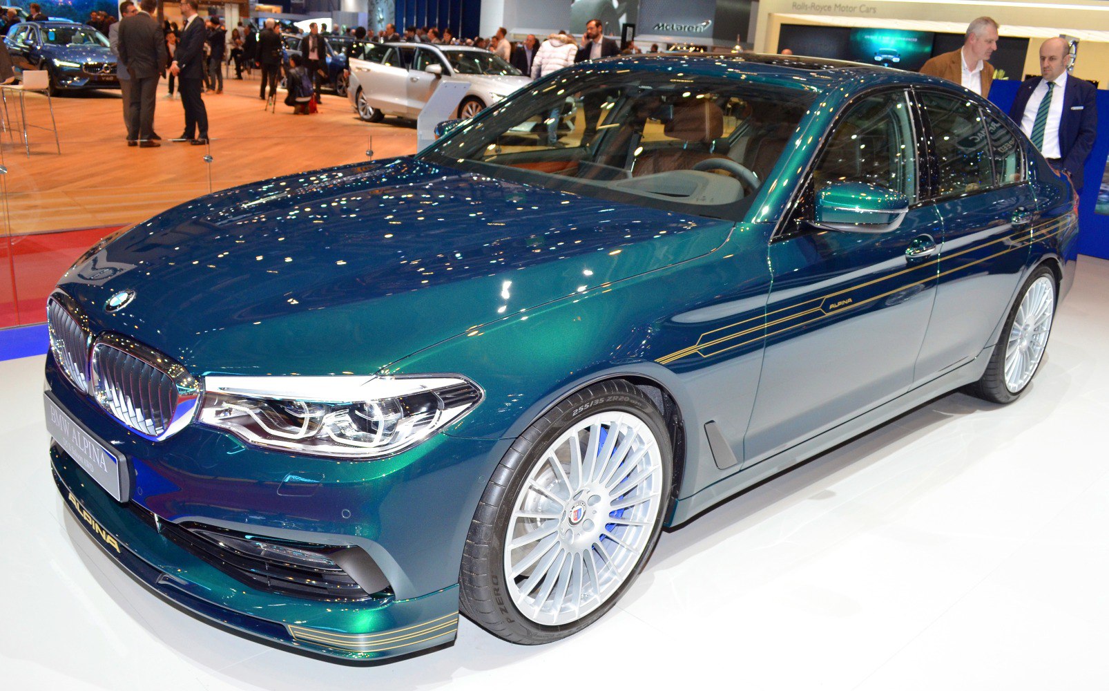 Front and side view of a sedan with distinctive multi-spoke alloy wheels and aerodynamic body kit